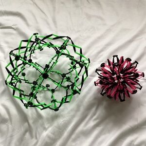 Two Expandable Green and Pink Sphere Toys
